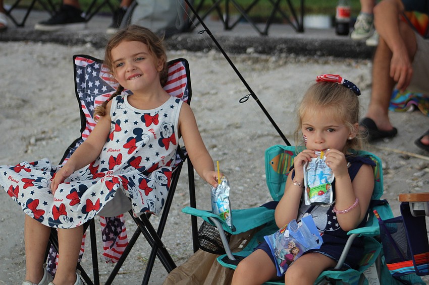 Northport's Delaney Goodrich and Nokomis' Emma Buffaloe sip on their juice boxes before the fireworks show.