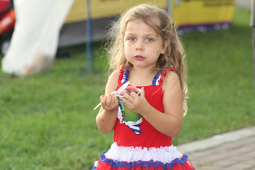 East County's Lila Hitt is spoon deep in her snow cone.