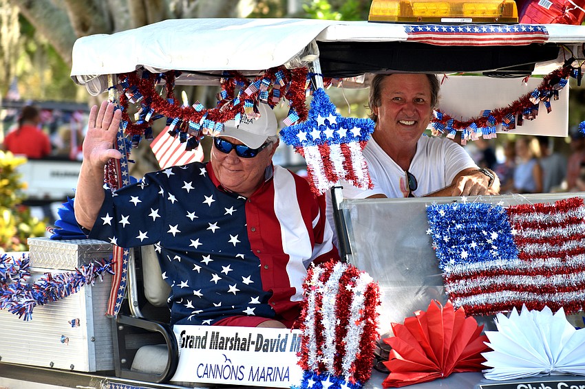 Grand Marshal David Miller and Longboat Key Chamber of Commerce Chairman Mike Doll wave to the crowd.