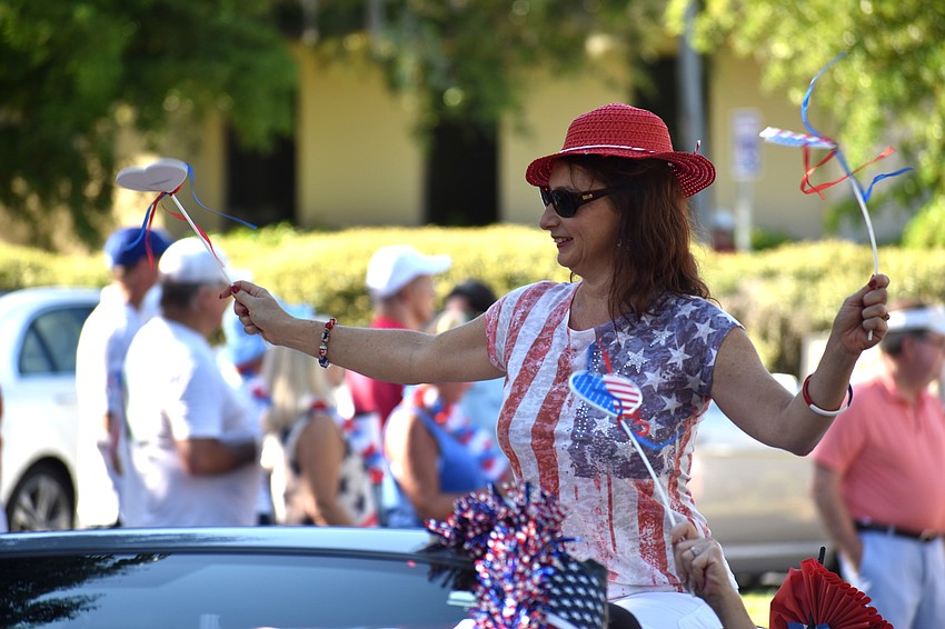 Irina LaRose waves to the crowd lined on Bay Isles Road.