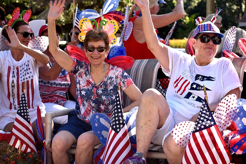 Longboat Key Garden Club members wave to the crowd during the 15th annual Freedom Fest parade.