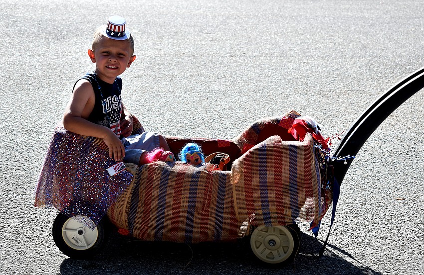 Matteo Laganella enjoys a wagon ride during the Freedom Fest Parade.