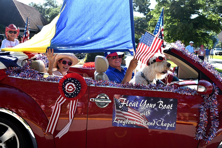 Longboat Island Chapel members wave to the crowd on Bay Isles Road. The Chapel was the winner of the $500 cash prize from Cannons Marina for the best business float.