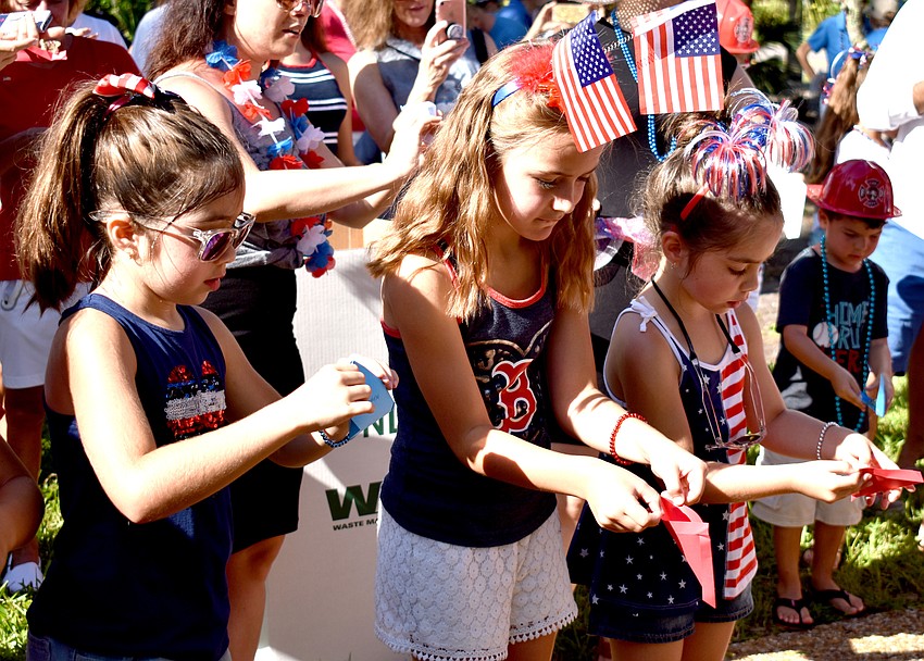 Isabella Shelton, Sophie Knight and Camille Shelton release their butterflies. Each year, the Longboat Key Garden Club sponsors a butterfly release following the parade.