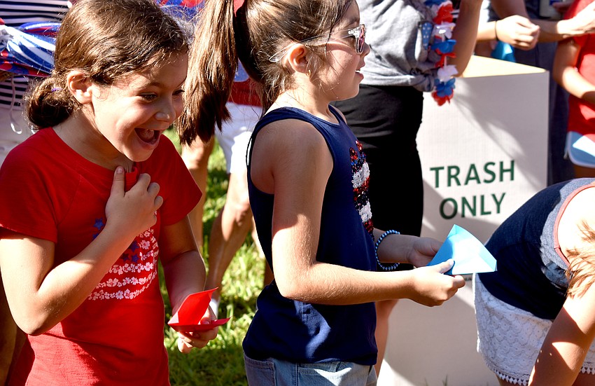 Isabelle Strulson smiles as her butterfly fly away.