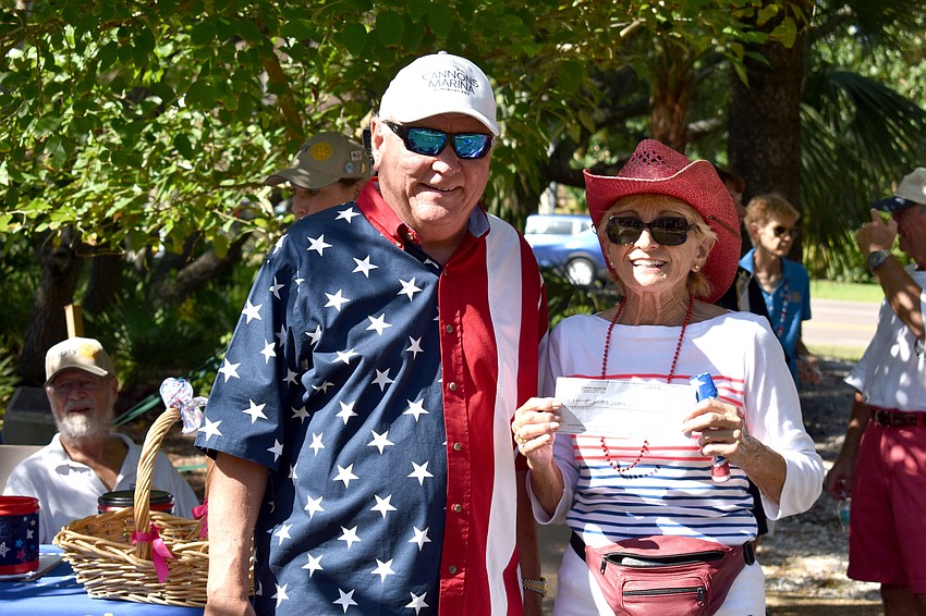 David Miller represented a check for $500 to members of Longboat Island Chapel, who won the prize for best business float.