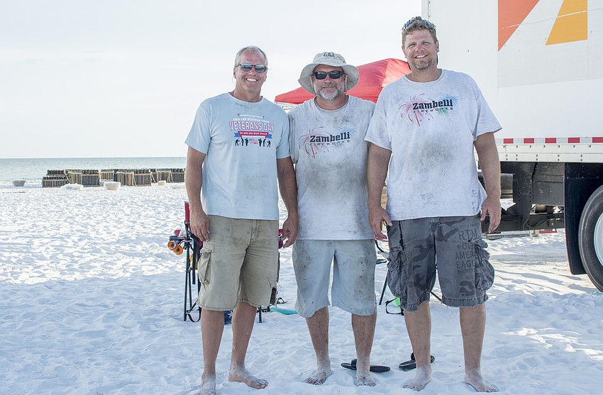Todd Snider, Craig Merrill and Andrew Thompson pose in front of   the fireworks for the Fourth of July fireworks show on Siesta Key.