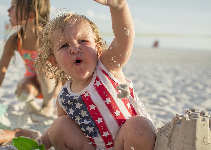 Zaely Wilson plays in the sand before the Siesta Key fireworks show.