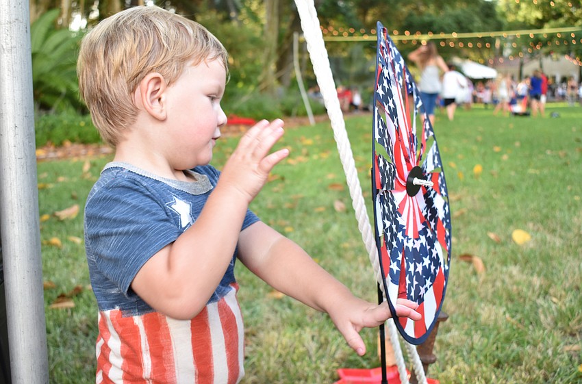 Shane Lance finds a patriotic pinwheel to play with.