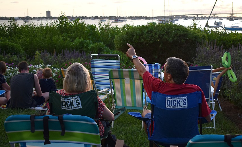 A couple waits for the Bayfront fireworks display in front of Michael’s on the Bay at Selby Gardens.