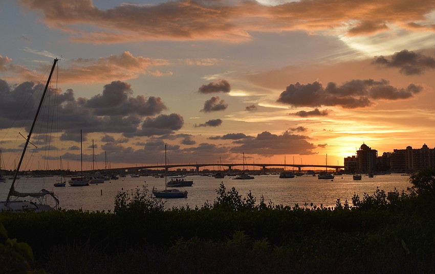 Spectators enjoyed a colorful sunset over Sarasota Bay before the fireworks show on Fourth of July outside Michael’s on the Bay at Selby Gardens.