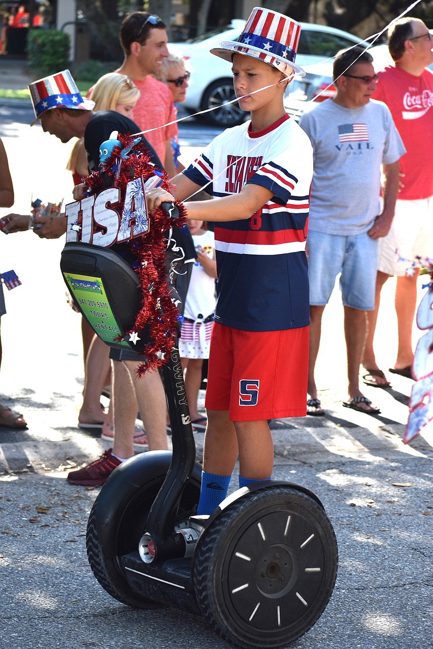 Sam Heintz and his brother, Alex, rode segways along the parade route.