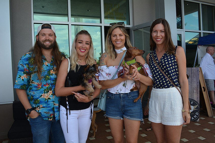 Reuben Young, Hannah Runge, Ali Leeming and Kelly Dowd enjoy the event with Runge's dog, Laveau, and Leeming's dog, Lola.