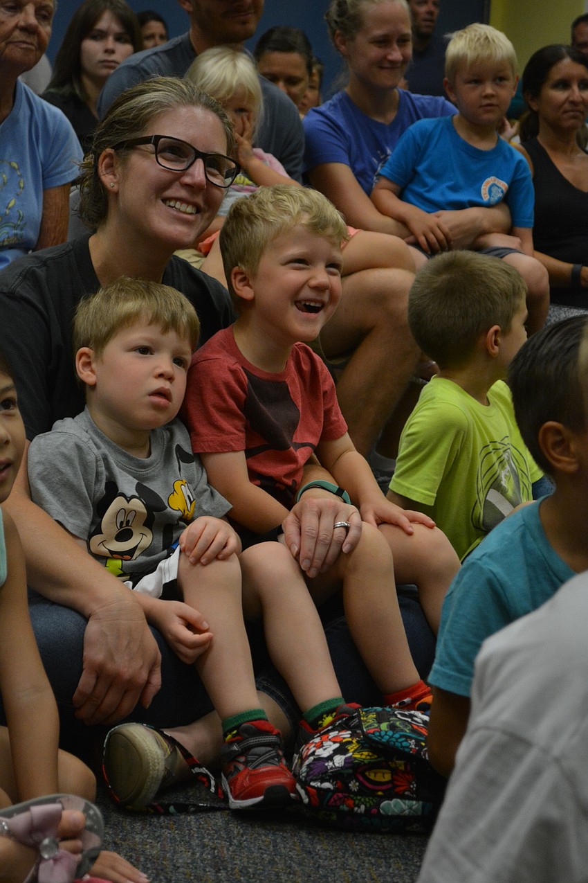 Christina Pattterson holds her boys, A.J., left, and Flynn, right. They are visiting family members Irene and Richard Rivera, of Heritage Harbour, from Maryland.