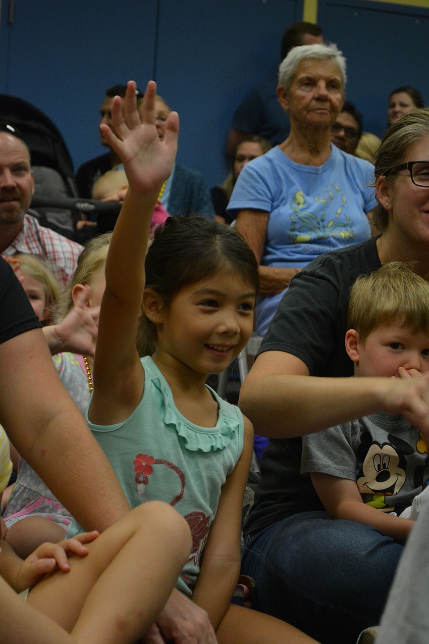 Cheomin Maugans, 5, of Central Park takes a guess at what creature eats a Savannah monitor.