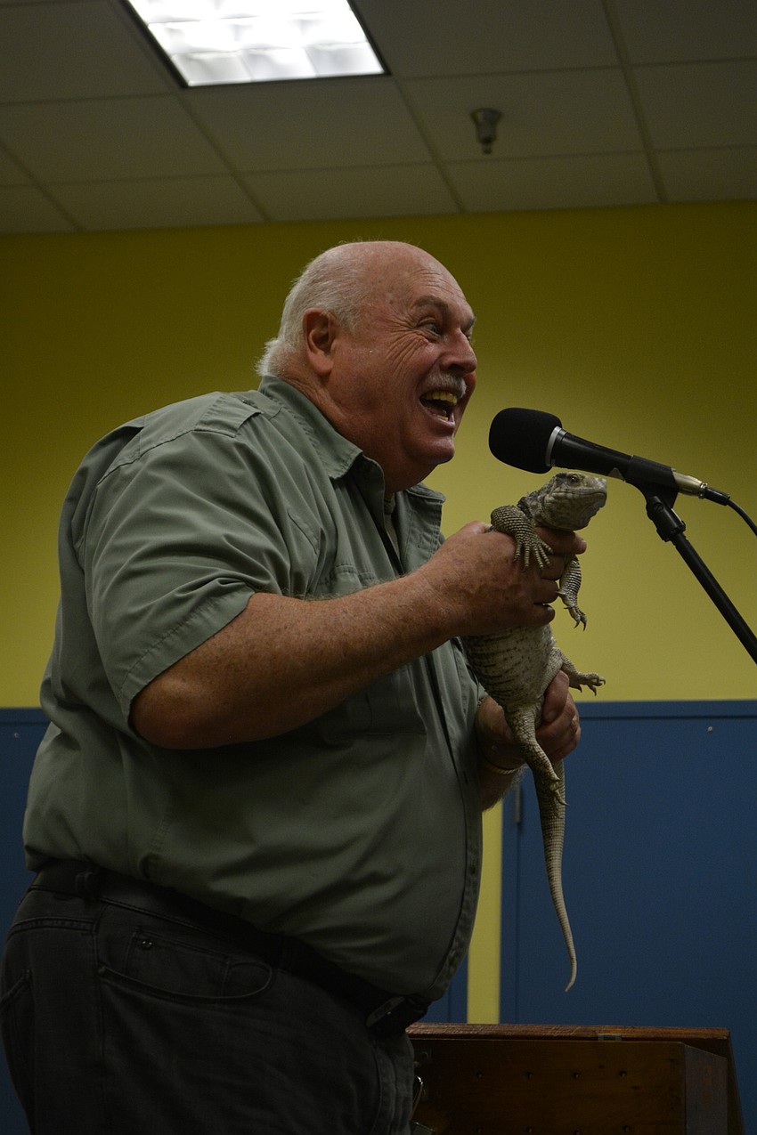 John Storms shows off a Savannah monitor, telling children how they can grow up to 5 feet long.