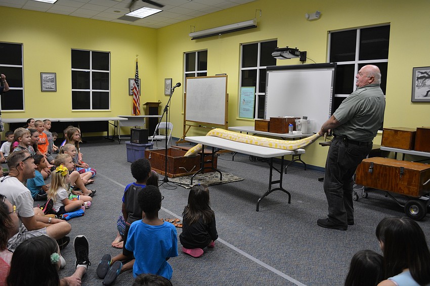 John Storms rolls out Jessie, his 16-foot python, as the finale to the presentation.