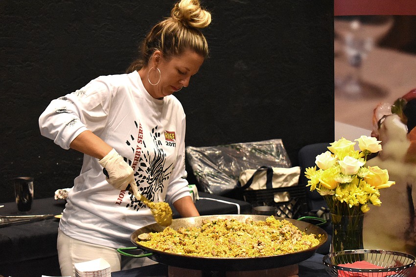 Nikki Logan Curran stirs the lionfish paella Mattison’s served at the tasting.