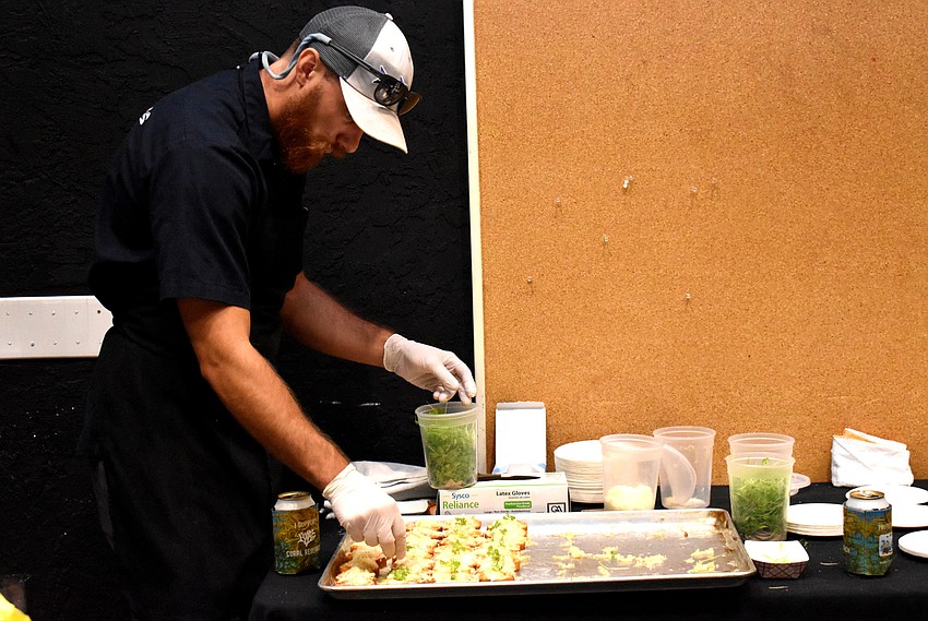 Robin Neff garnishes Indigenous’ baked lionfish garlic toast.