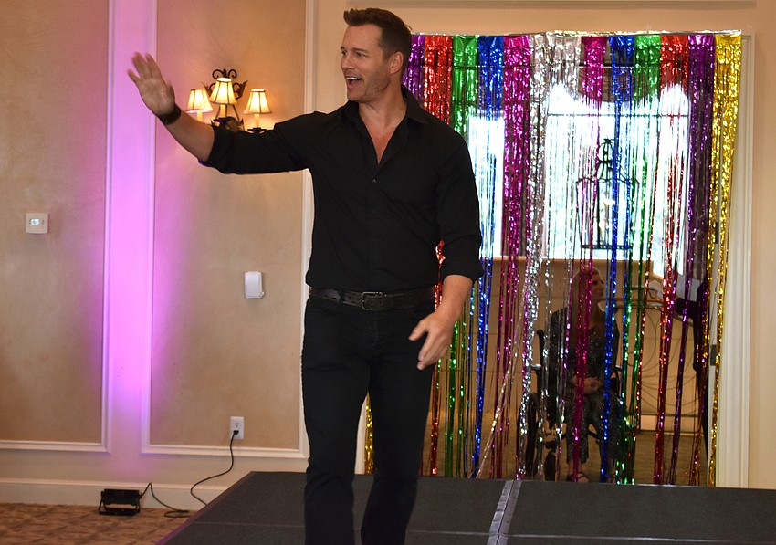 Eric Martsolf waves to guests from the runway.