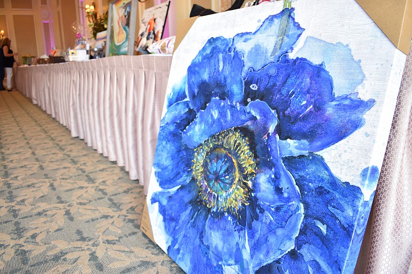 A piece of artwork depicting a blue violet was one of several items in the silent auction.