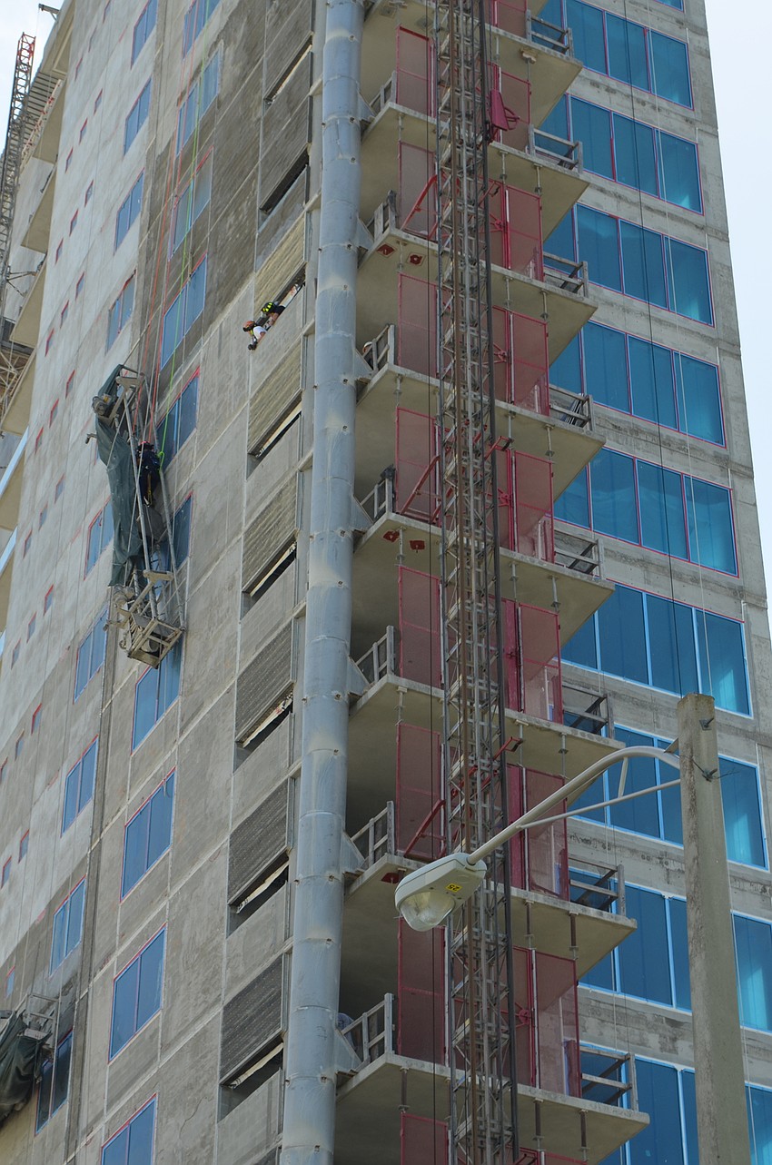 The worker was unable to get down after a mechanical failure caused one end of the scaffolding along the building to rise up.
