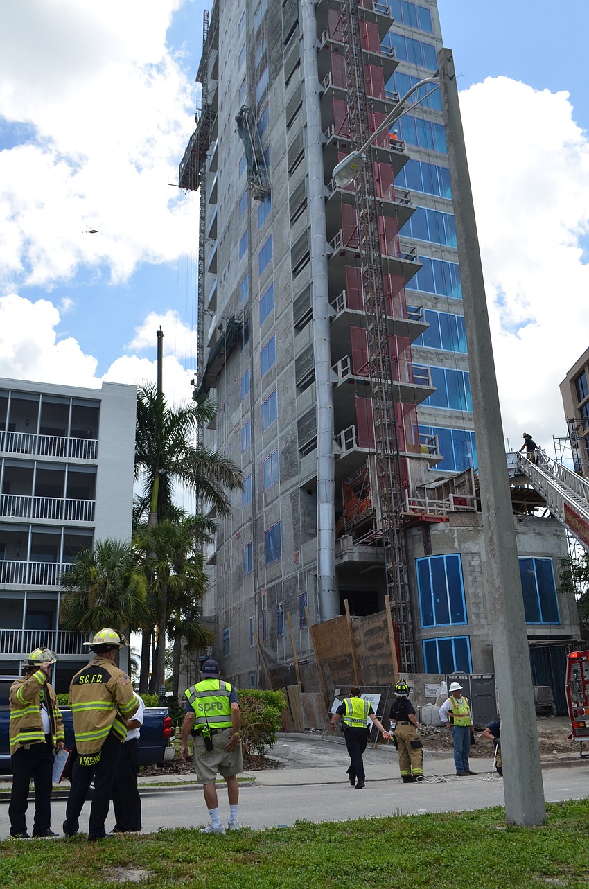 Emergency services workers look on in the wake of a high-angle rescue at a Palm Avenue construction site.