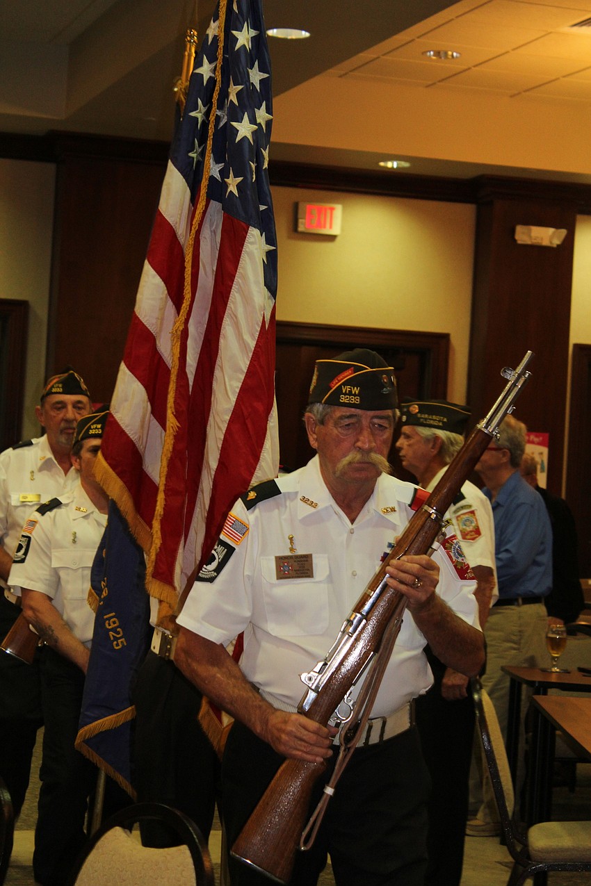 Members of the Sarasota Honor Guard Post 3233 present the American flag.