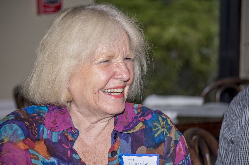 Judie Smith laughs during the opening remarks.