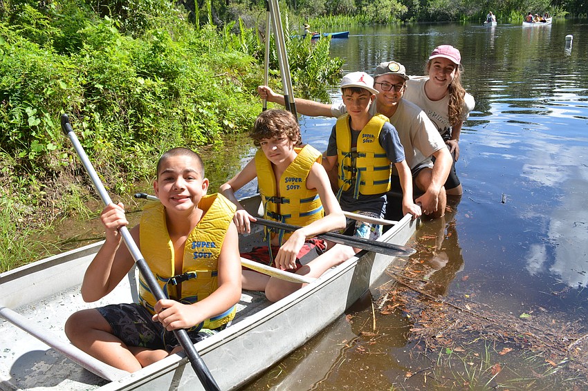 Benson Dean, Jonathan Luallen, Brandon Cafee and counselors Josh Audet and Arielle Teets push off into the Manatee River.