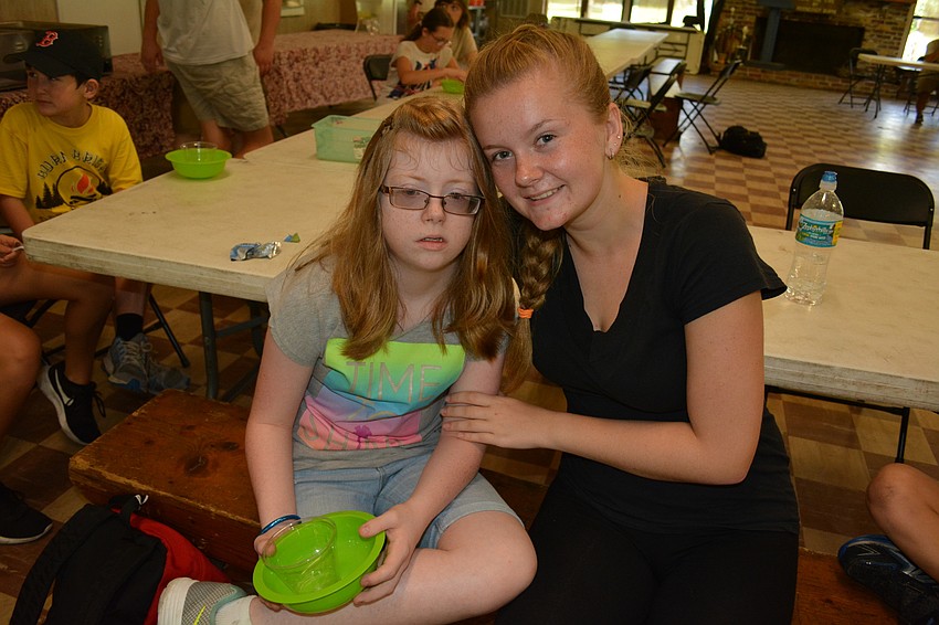 Gracie Pfotenhauer, 11, of Gullett Elementary, makes a potion with the help of counselor Phoebe Bond, of Lakewood Ranch High School.
