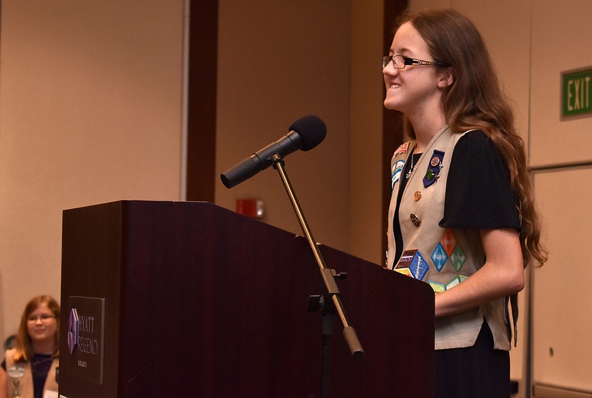Girl Scout Emily Mayo, participating in the event for her third year in a row, introduces U.S. Air Force veteran C.J. Bannister.