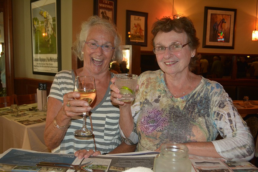 Lakewood Ranch's Nancy Morningstar and Bradenton's Sheila Noyes lift a glass before heading for the buffet line.