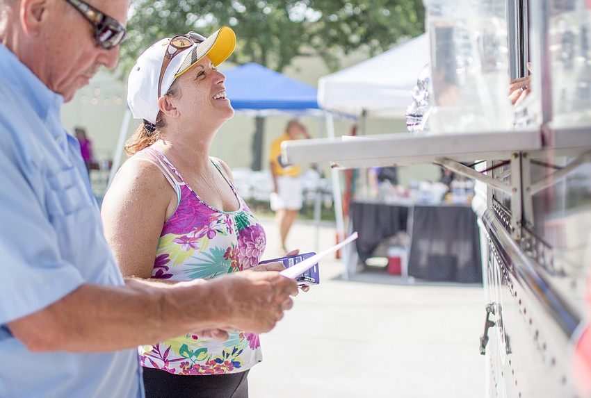 Janene Jones orders from Smoking Bowls food truck.