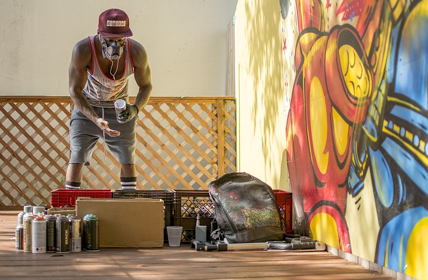 Richie Brasil paints a wall of JDub's beer garden during JDub's one-year anniversary food truck rally.