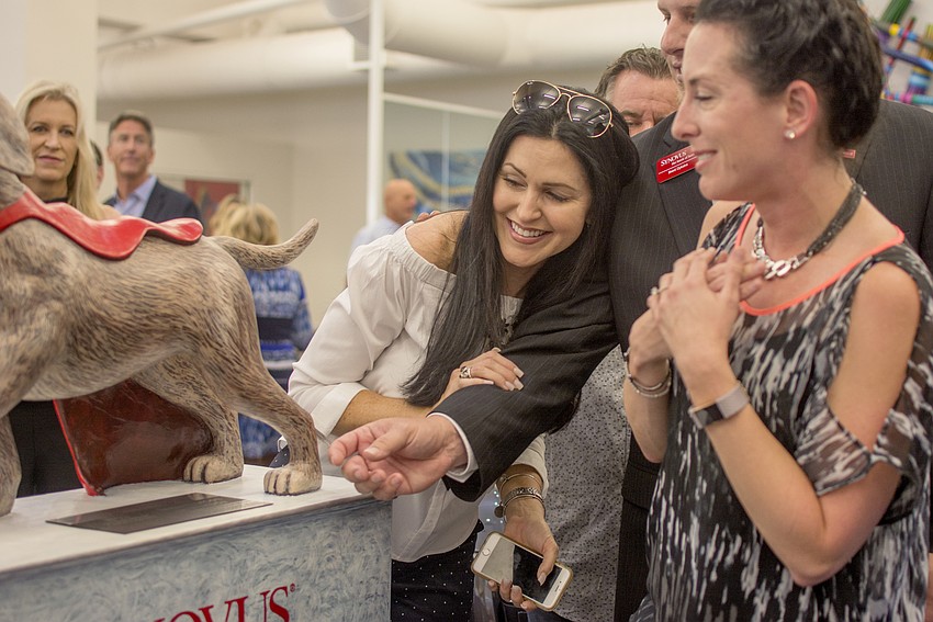 Salena Wilhoit reacts after SYNOVUS's statue Chief was revealed.