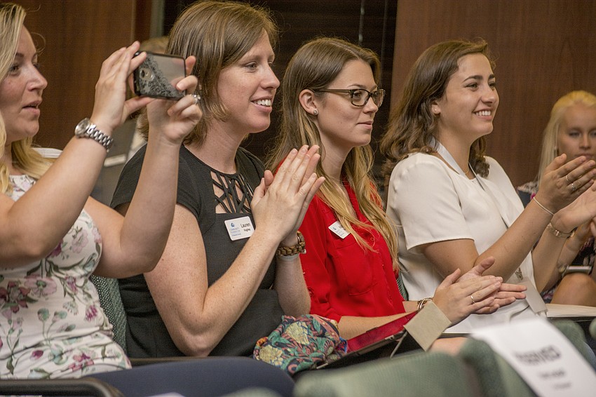 Audience members applaud as the Young Professional of the Year award finalists are announced at the YPG Summit.
