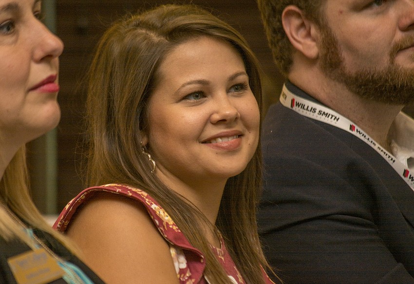 Young Professional of the Year Award finalist Britney Guertin smiles while being introduced during the YPG Summit.