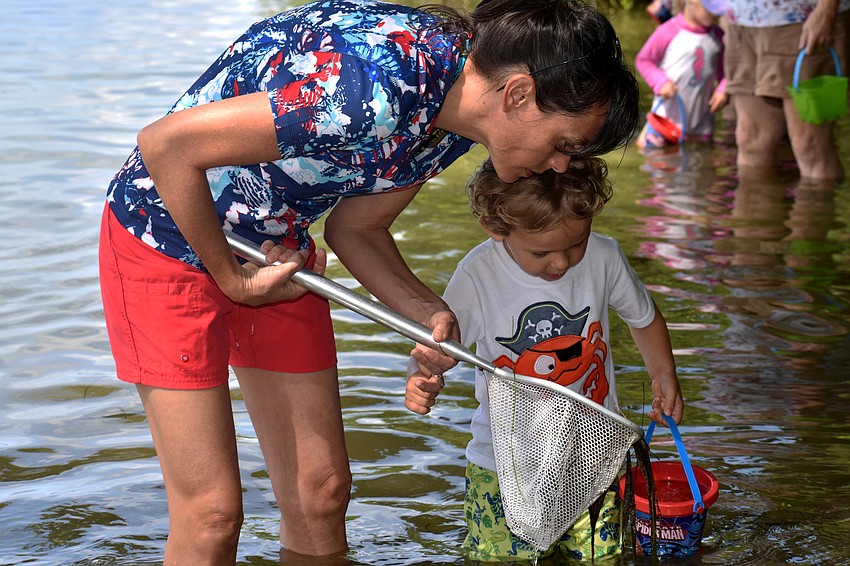 Tiffany and Beau Sanson check their net for marine life.