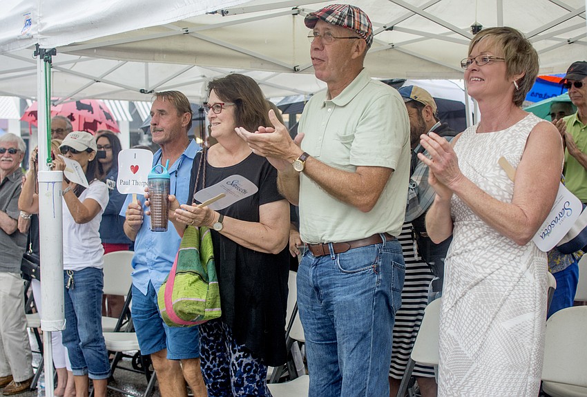 Residents and city staff gathered under tents and umbrellas during the renaming ceremony.