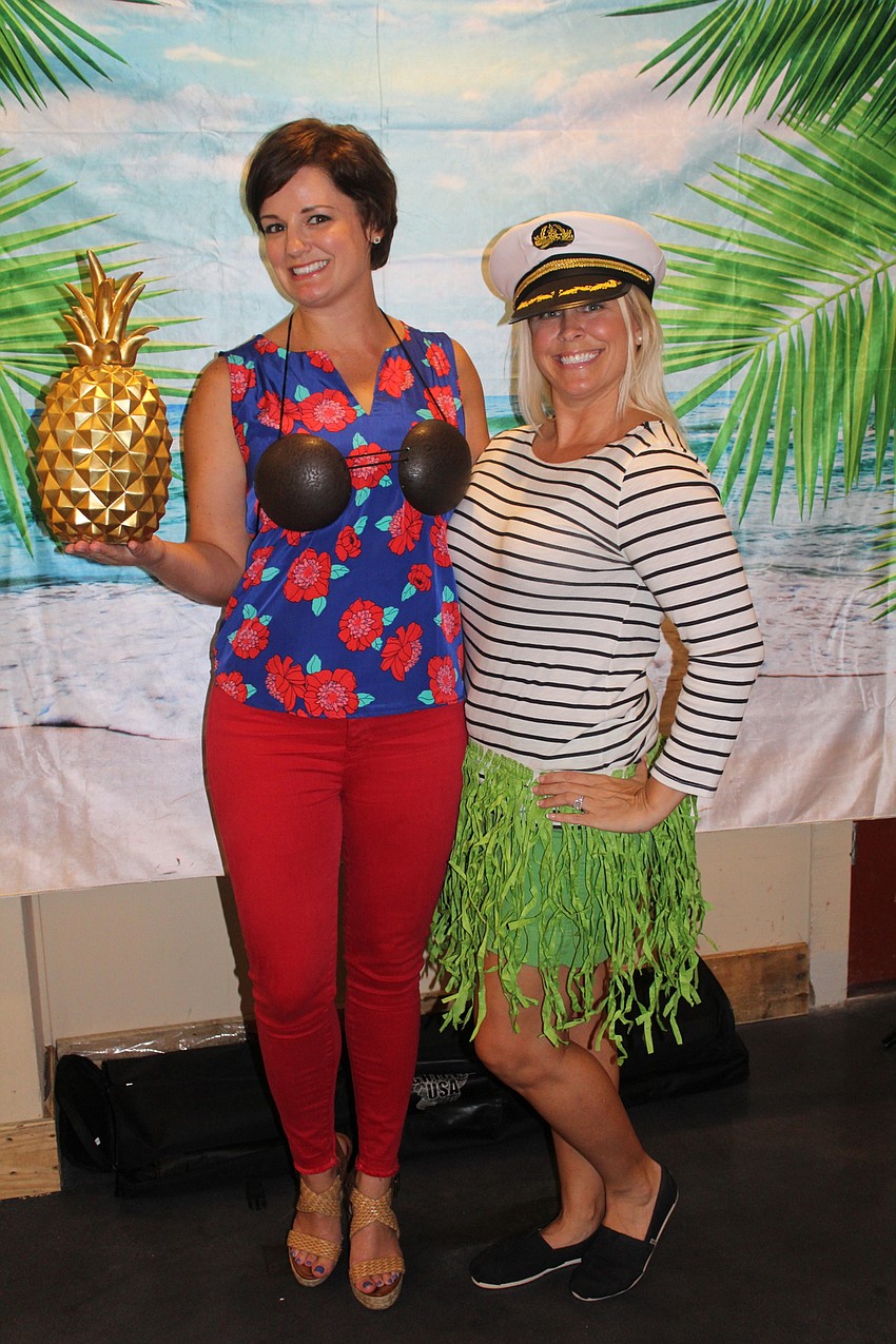 East County's Jill Gass and Parrish's Heather Roembke try out the tropical photo booth.