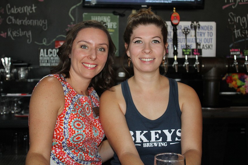 Cheers for Charity member Michelle Cross gets tips from 3 Keys Brewing and Eatery bartender Kira Ceriga.