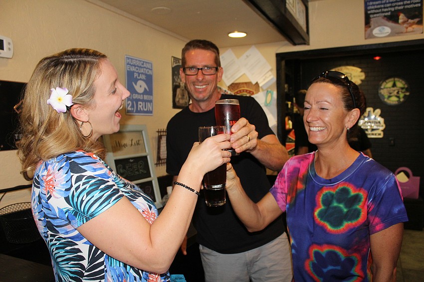 East County's Sierra Butler, Mike Gilkison and Stacey Gilkison toast during the event.