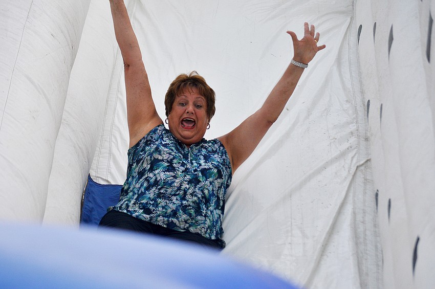 Alta Vista Elementary School Principal Barbara Shirley slides down the inflatable slide during Alta Vista's Eagle Fest.