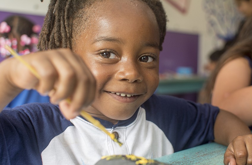 Kylin Love paints a rock in the mobile craft truck available at Alta Vista's Eagle Fest.