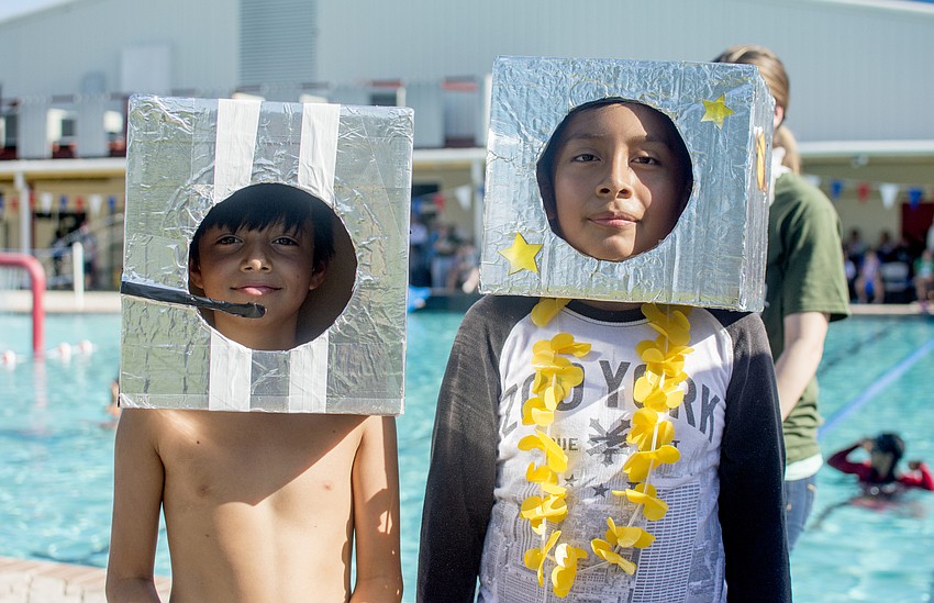 Mario and Jose pose with their space helmets to match their space-themed boat.