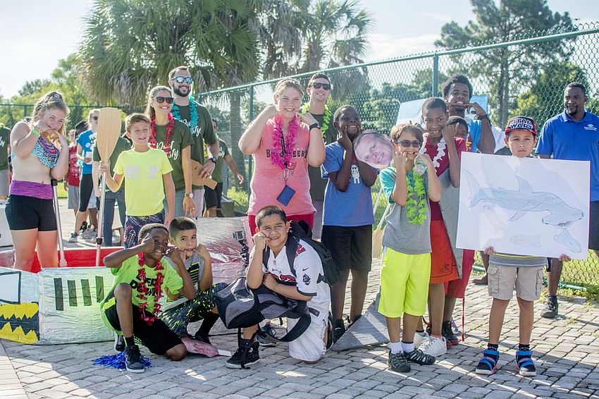 Team Shark poses with their boat before participating in the the inaugural Rock the Boat Regatta that the Boys and Girls Club.
