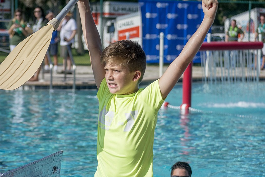 Max celebrates after winning his race in the  inaugural Rock the Boat Regatta that the Boys and Girls Club.