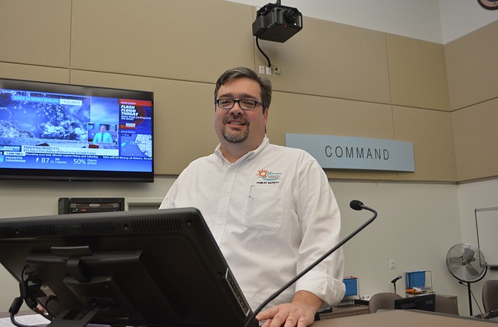 Bob Smith, the county's director of public safety, takes the main podium in the Emergency Operations Center. "If I'm in here, it's really bad," he says.