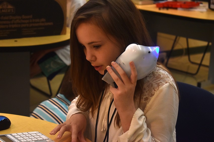 Byrne Markham tests out the Finch Robot.